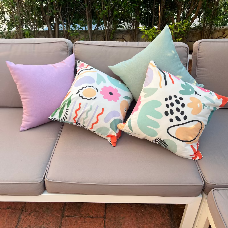 White cushion with pastel abstract shapes in a modern artistic pattern