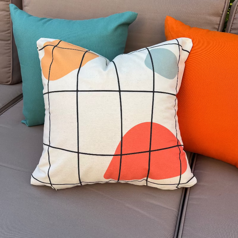 White cushion with black grid lines and abstract colored shapes in a modern geometric design