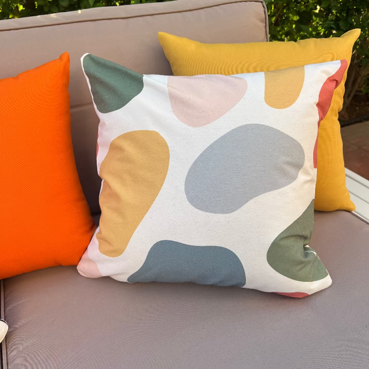 White cushion with black grid lines and abstract colored shapes in a modern geometric design