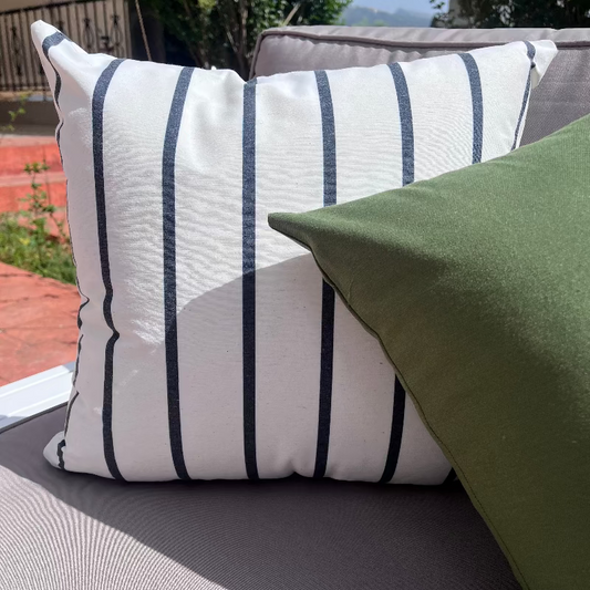 White cushion with thin black vertical stripes in a modern minimalist design