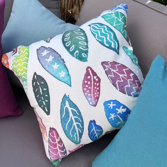 Colorful leaf pattern decorative cushion with watercolor botanical design on white fabric