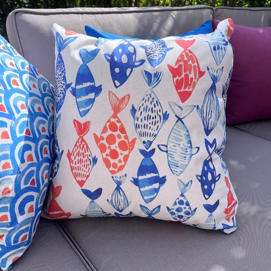 Colorful fish pattern cushion cover with blue and orange marine design on white decorative pillow
