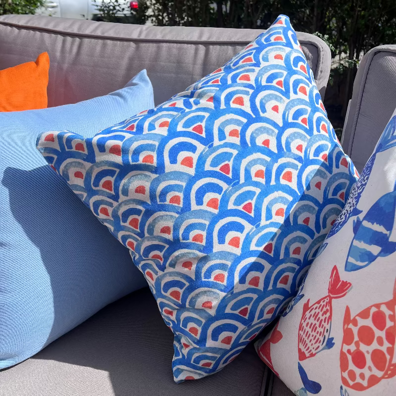Blue geometric wave pattern cushion cover with repeating ocean-inspired design on decorative pillow