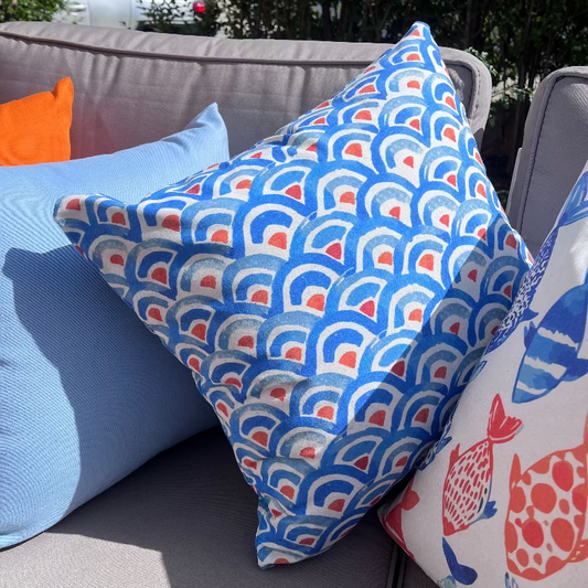 Blue geometric wave pattern cushion cover with repeating ocean-inspired design on decorative pillow