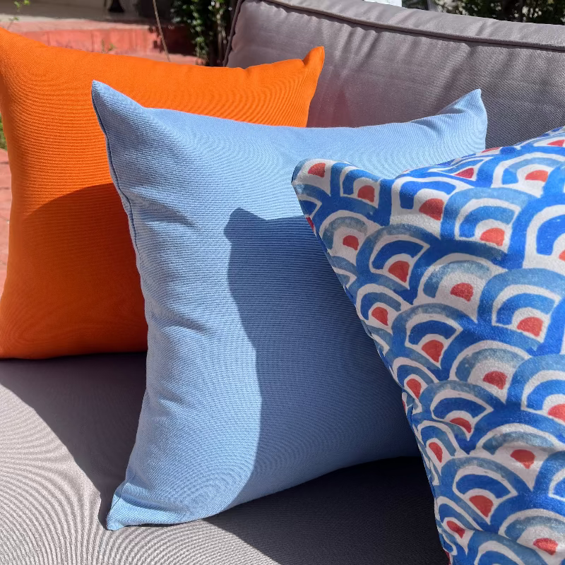 Blue geometric wave pattern cushion cover with repeating ocean-inspired design on decorative pillow