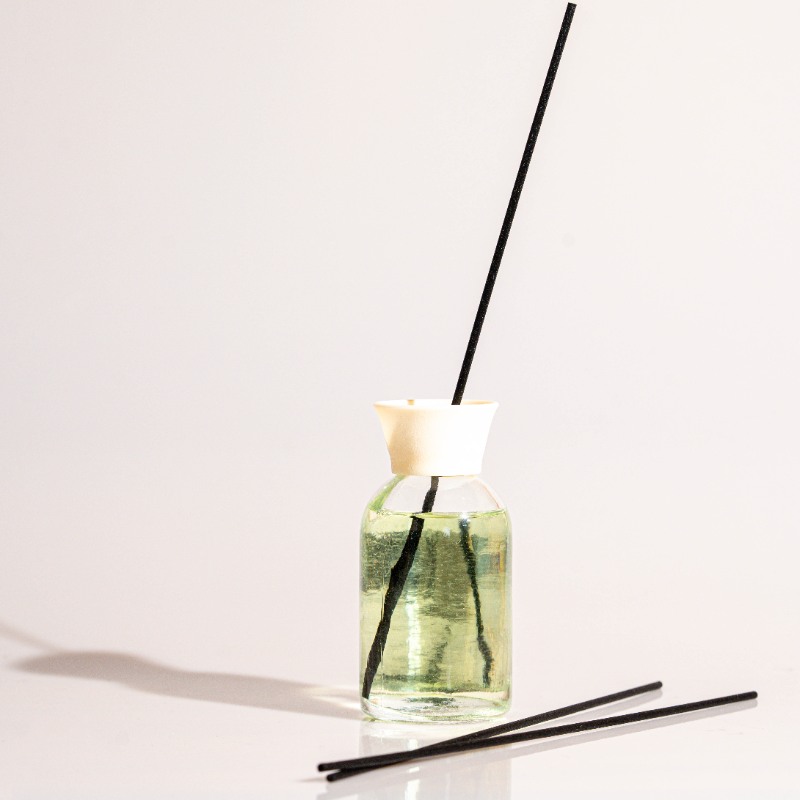 Elegant glass white soap reed diffuser with fragrance oil and natural sticks for home fragrance