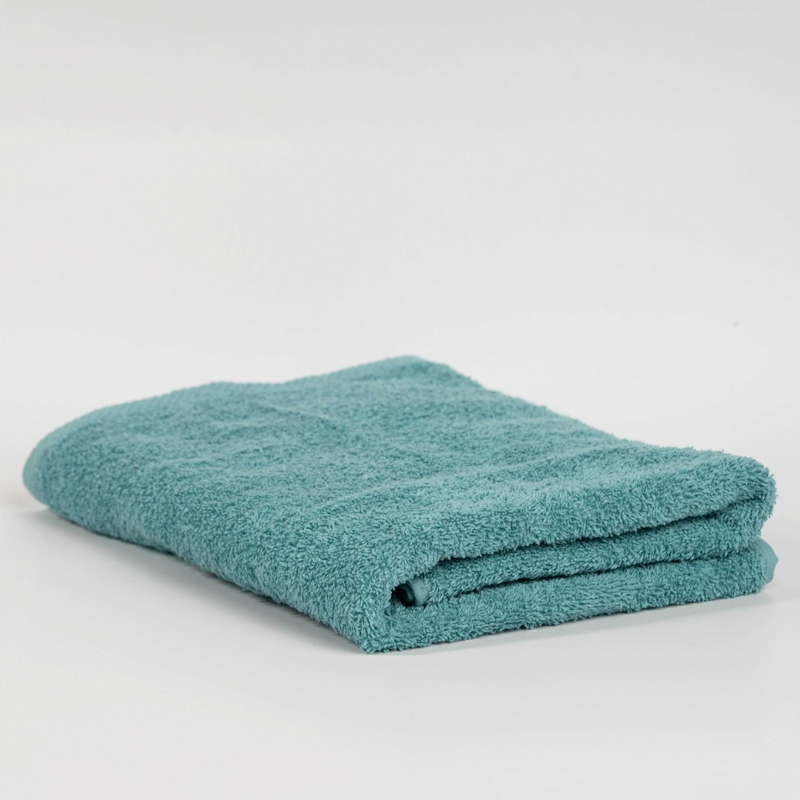 Absorbent pastel green cotton towel folded neatly.