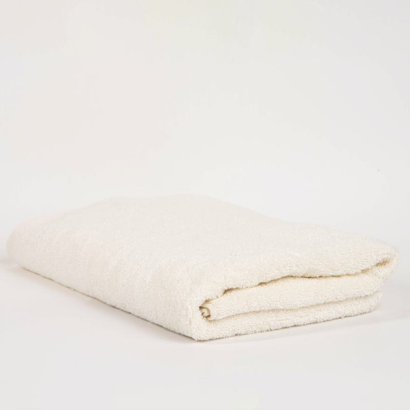 Absorbent cream cotton towel folded neatly.