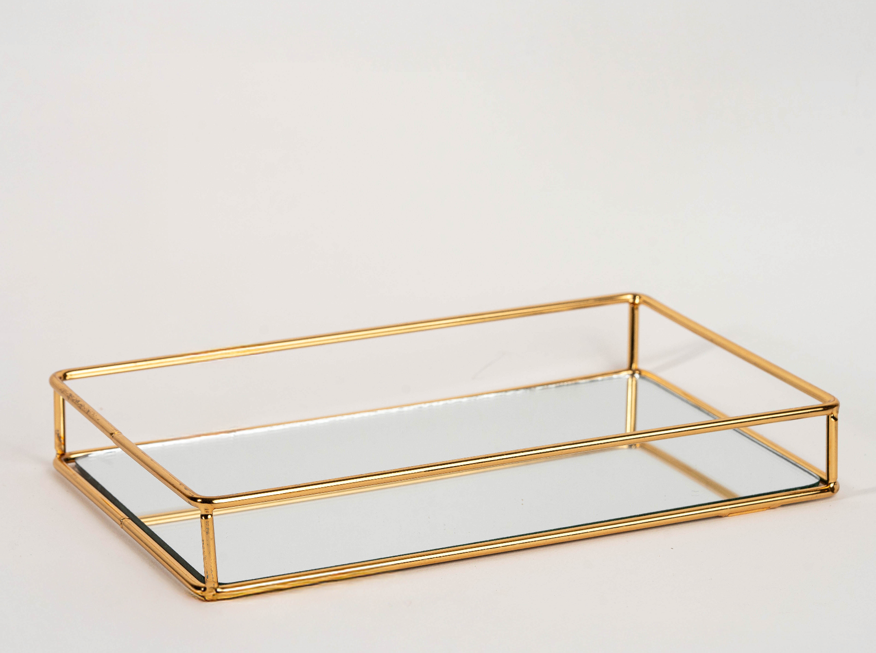Elegant rectangular gold mirror tray with metal frame for home décor and serving"