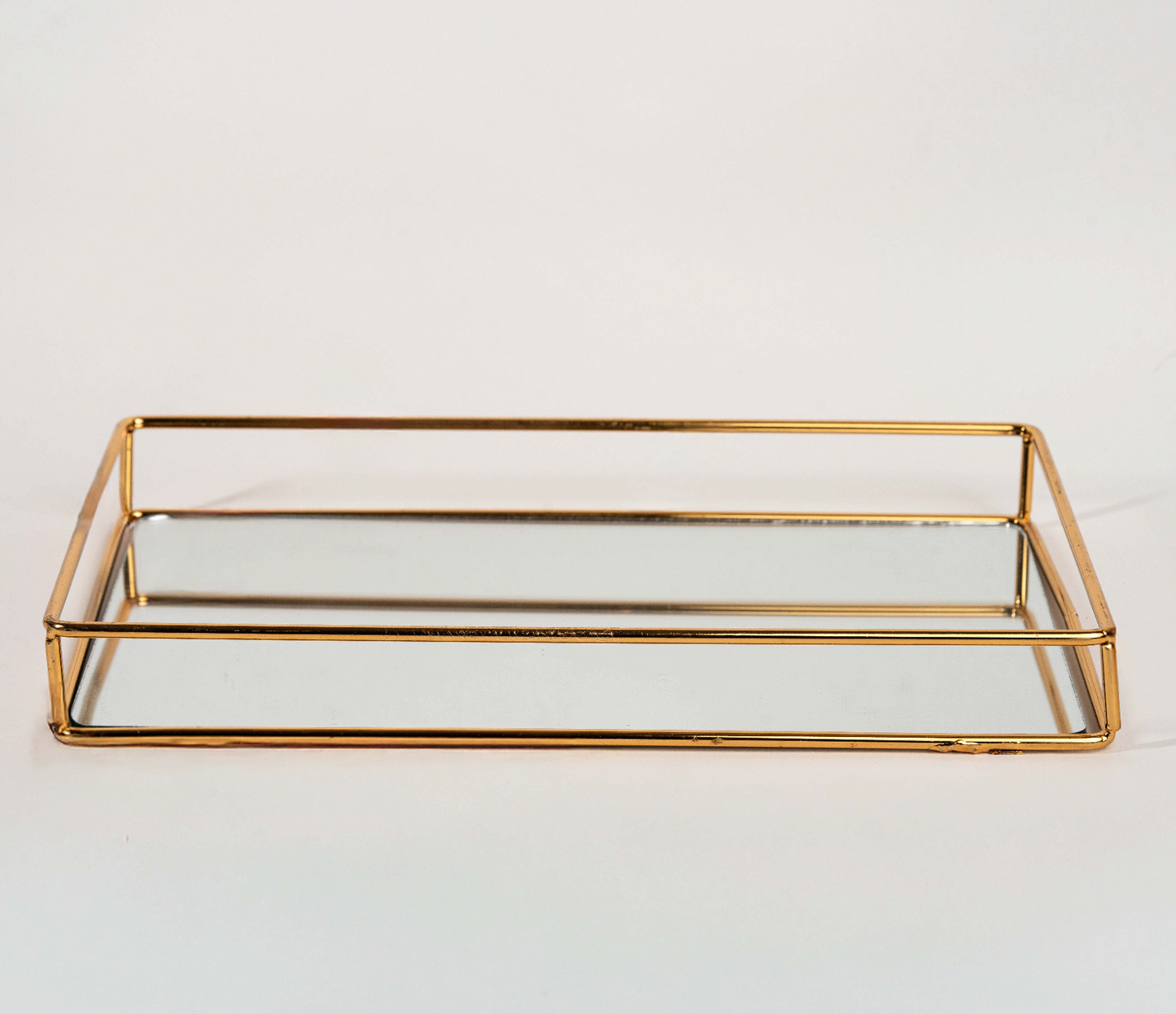 Elegant rectangular gold mirror tray with metal frame for home décor and serving"