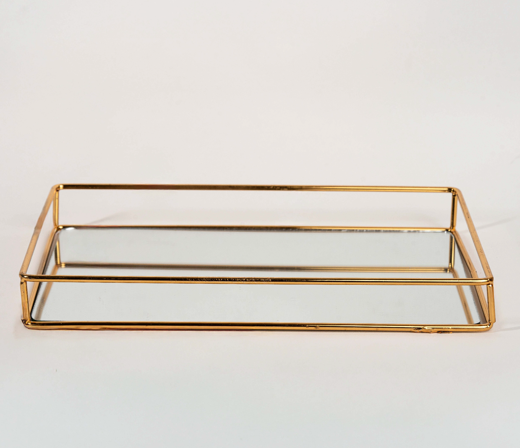 Elegant rectangular gold mirror tray with metal frame for home décor and serving"