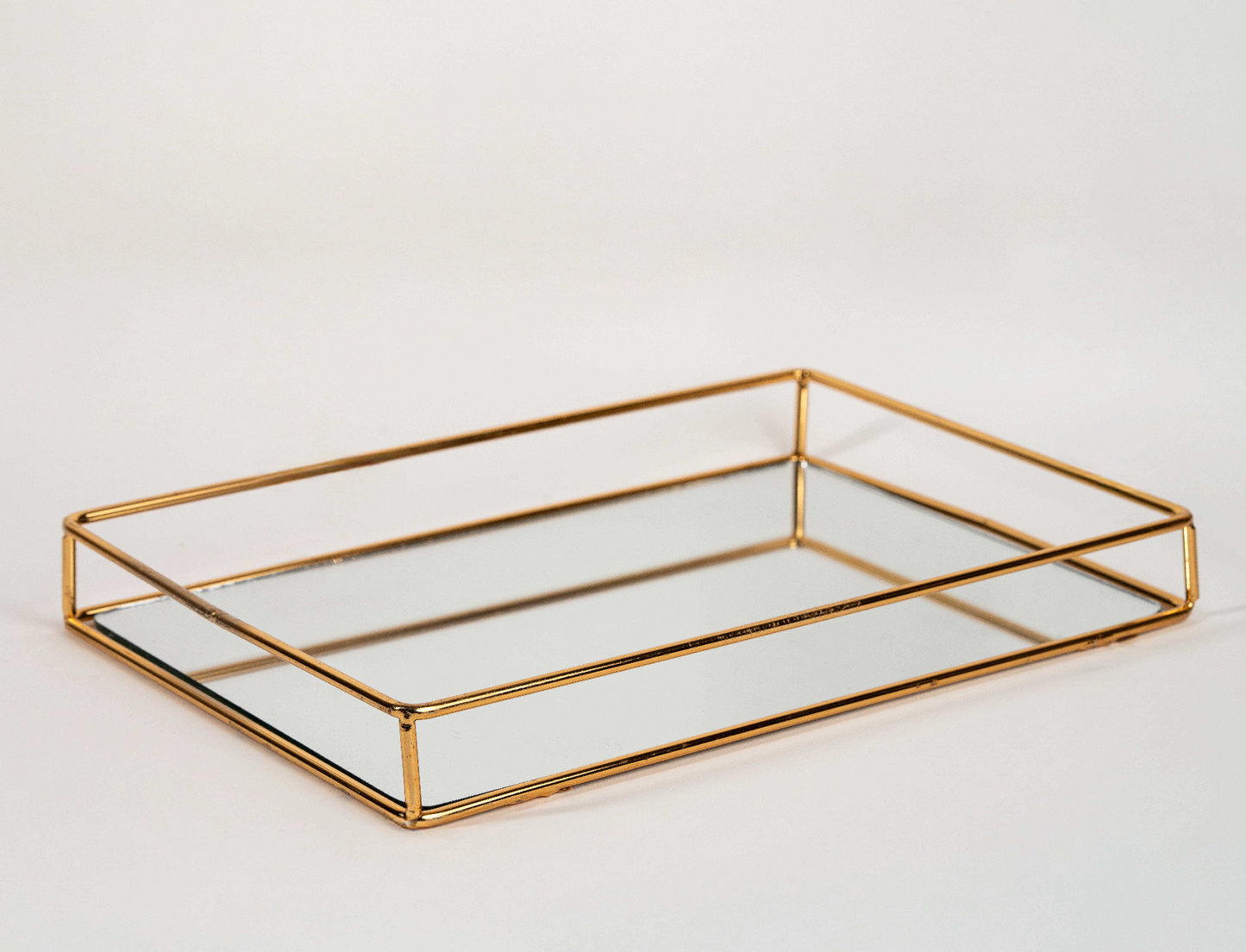 Elegant rectangular gold mirror tray with metal frame for home décor and serving"