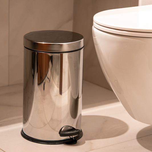 Stainless steel pedal bin next to toilet in modern bathroom