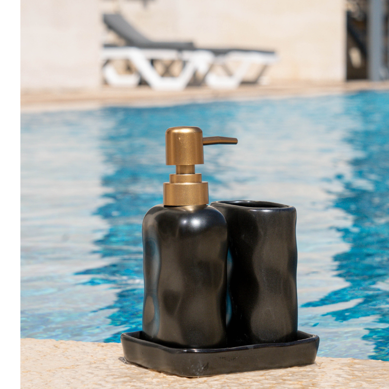 Luxury stone-effect soap dispenser and tumbler set with tray by the poolside