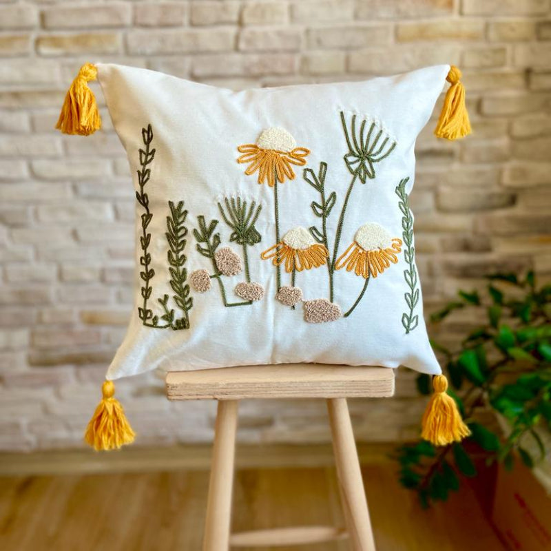 Handcrafted decorative throw pillow with floral embroidery featuring yellow flowers, green leaves, and yellow tassels