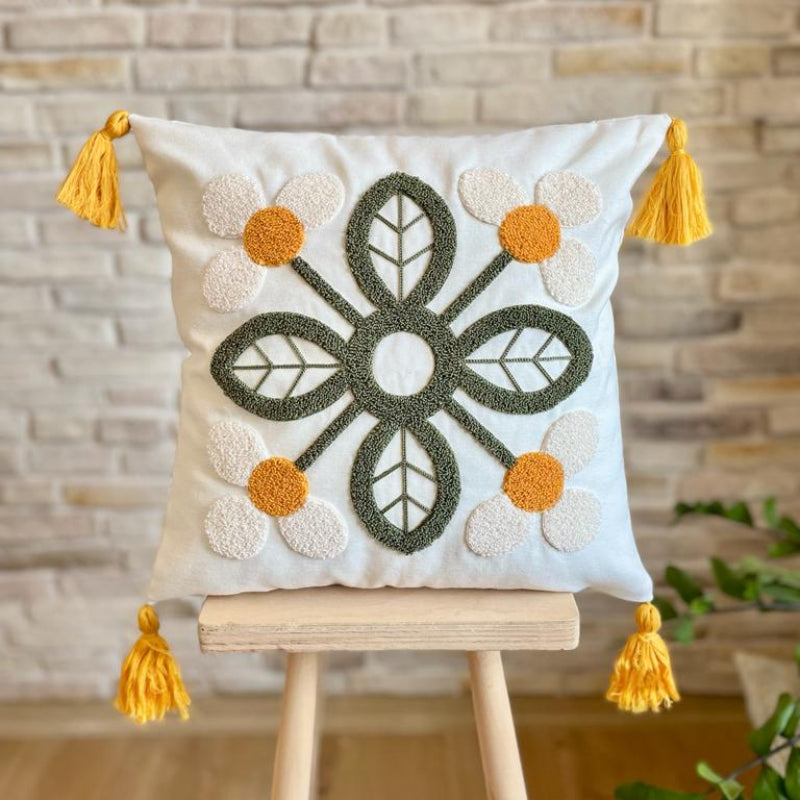 Handcrafted decorative throw pillow with floral embroidery featuring white flowers, orange centers, and yellow tassels