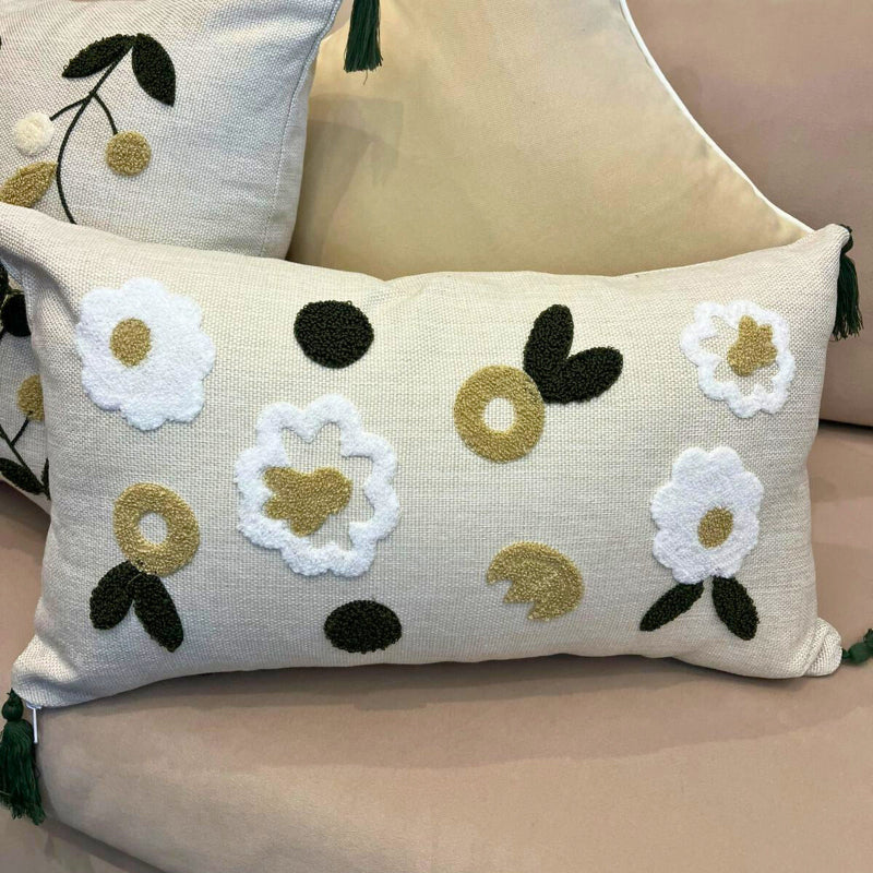 Rectangular embroidered floral cushion cover with tassels on beige sofa