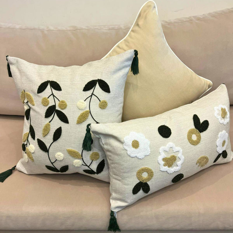 Rectangular embroidered floral cushion cover with tassels on beige sofa