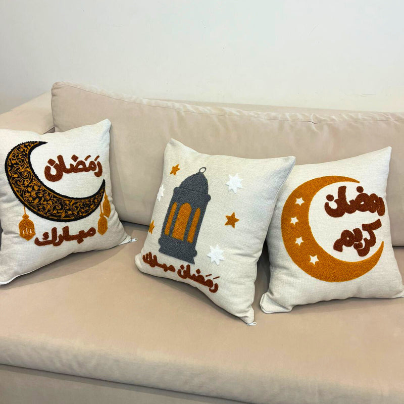 Square cushion cover with embroidered crescent moon and Arabic Ramadan Mubarak text on sofa