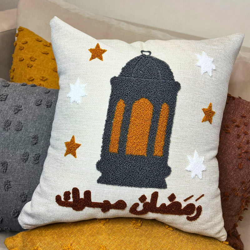 Square cushion cover with embroidered Ramadan lantern and Arabic Ramadan Kareem text on sofa
