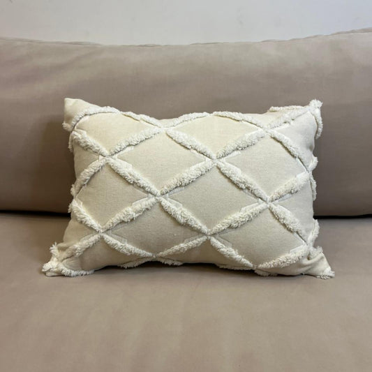 Ivory textured decorative cushion cover with raised diamond pattern on beige sofa