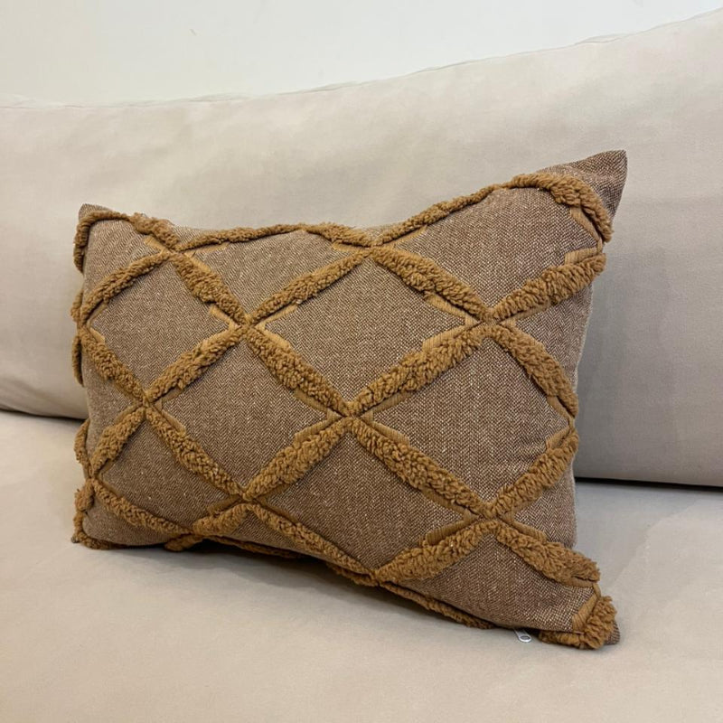 Mocha brown textured decorative cushion cover with raised diamond pattern on cream sofa