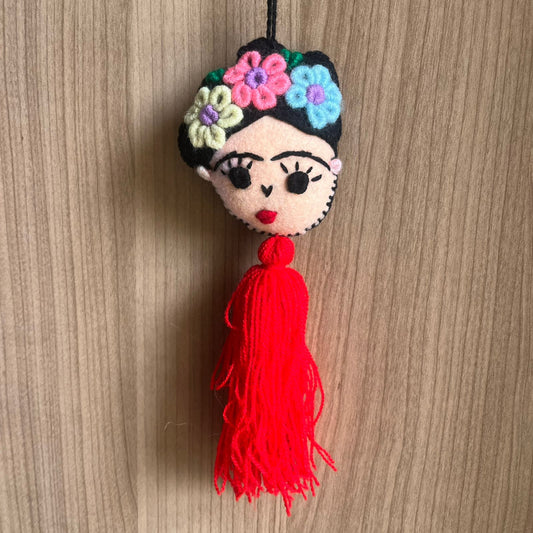 Handmade Frida Kahlo inspired felt ornament with embroidered flowers and red tassel hanging decor