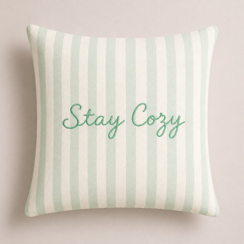 Sage green and white striped decorative cushion cover featuring Stay Cozy text in elegant script lettering