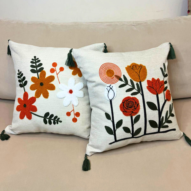 Modern embroidered floral cushion cover with tassels and vertical flower design on beige sofa