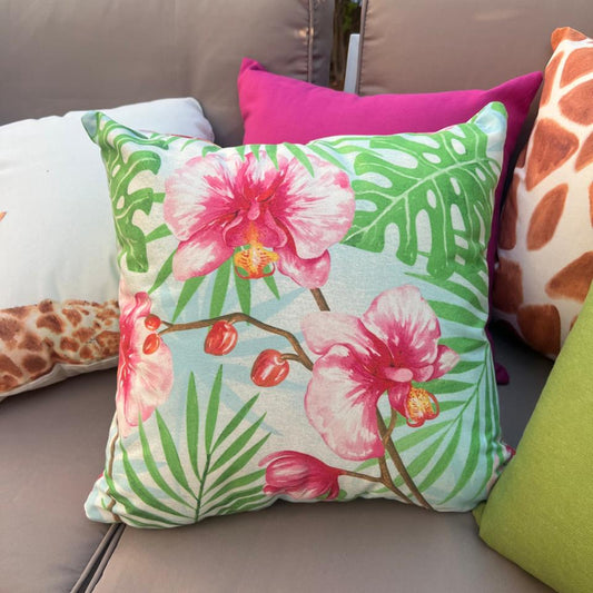 Tropical orchid cushion cover with pink flowers and green leaves on blue background decorative pillow