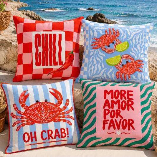 Colorful coastal summer cushion covers with red crabs, chili pepper, blue stripes and More Amor Por Favor designs.