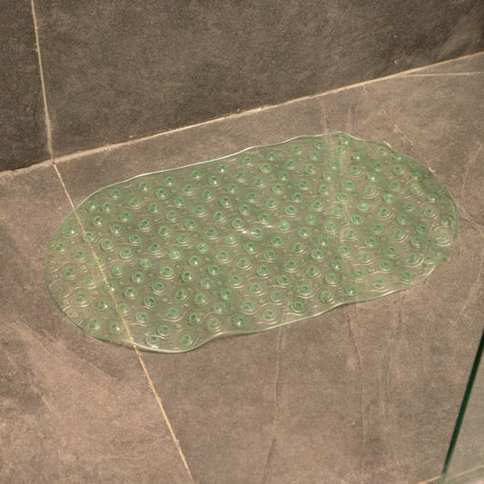 Green anti-slip capsule rubber shower mat on gray tiled bathroom floor
