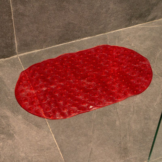 Red anti-slip capsule rubber shower mat on gray tiled bathroom floor