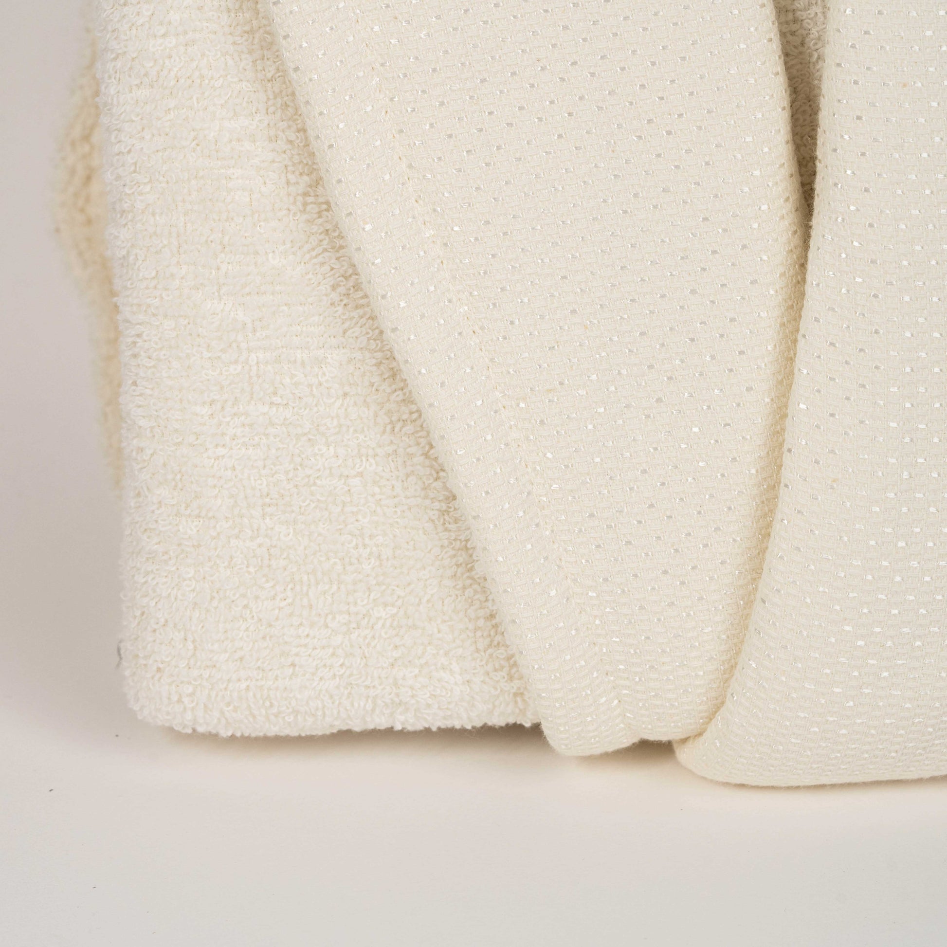 Unisex cotton terry bathrobe with shawl collar and waist belt, worn by woman near window in natural light
