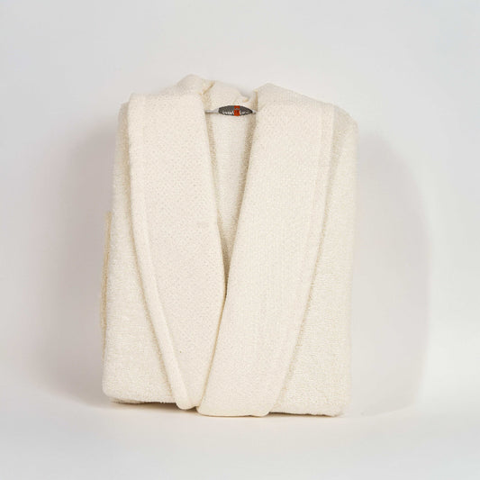 Unisex cotton terry bathrobe with shawl collar and waist belt, worn by woman near window in natural light