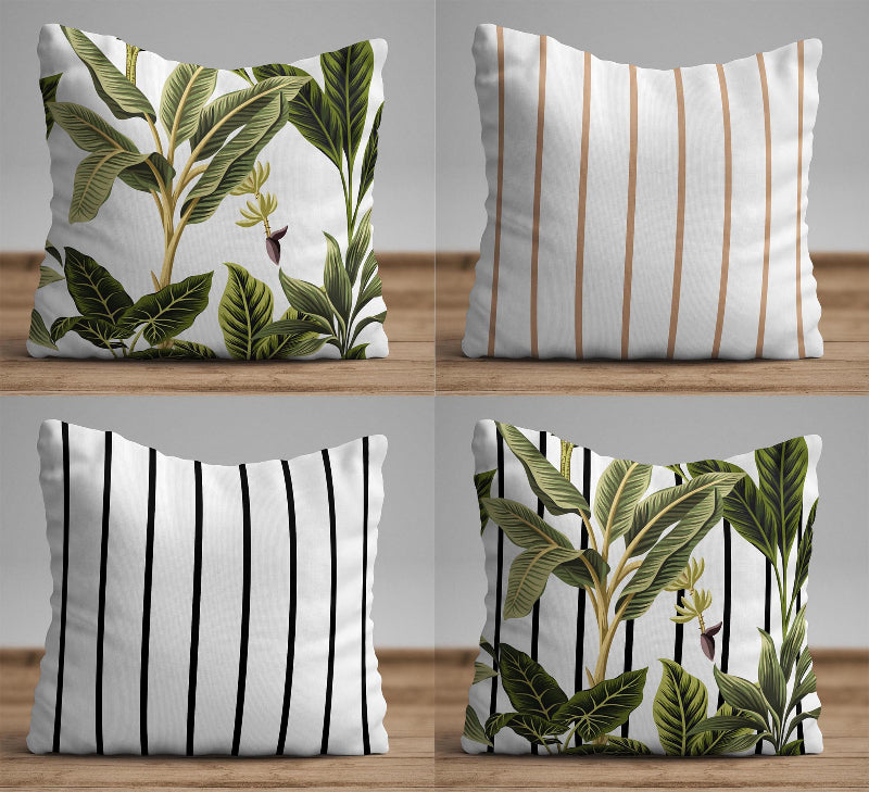 Tropical leaf cushion cover with green botanical design over black and white striped background