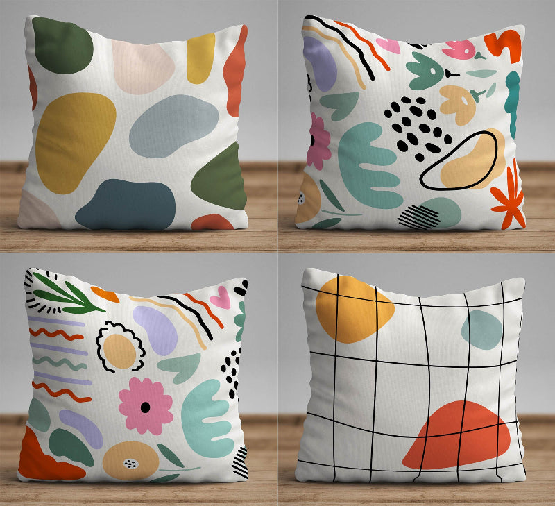 White cushion with colorful abstract shapes in a modern artistic pattern