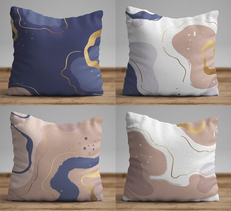 Neutral cushion cover with abstract shapes in beige, blue, and soft gold accents on a modern decorative pillow