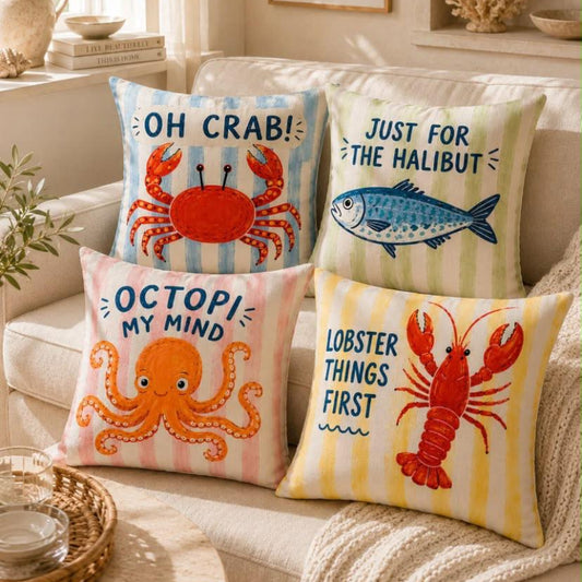 Colorful coastal cushion covers with crab, lobster, octopus and fish designs styled on a beige sofa