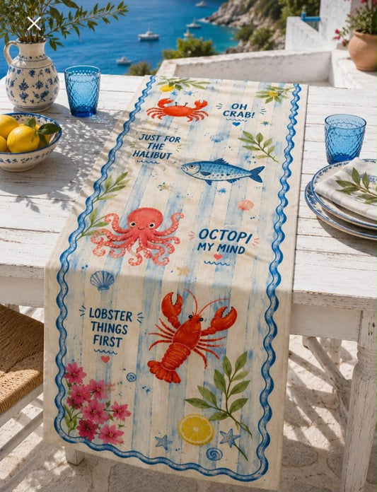 Coastal sea life table runner with lobster, crab, octopus, fish, lemons and blue nautical border on outdoor dining table