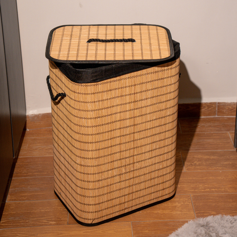Rectangle bamboo laundry basket with lid and black fabric lining.
