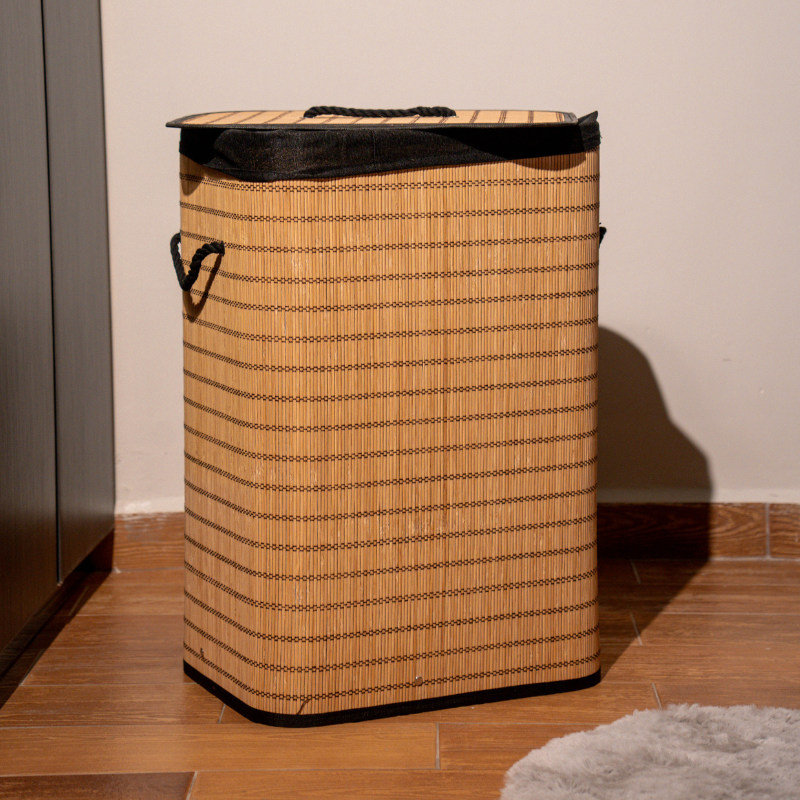Rectangle bamboo laundry basket with lid and black fabric lining.