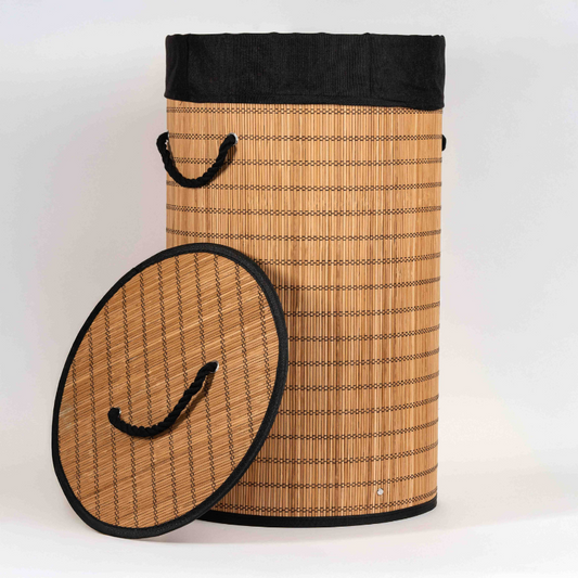 Round bamboo laundry basket with lid and black fabric lining.