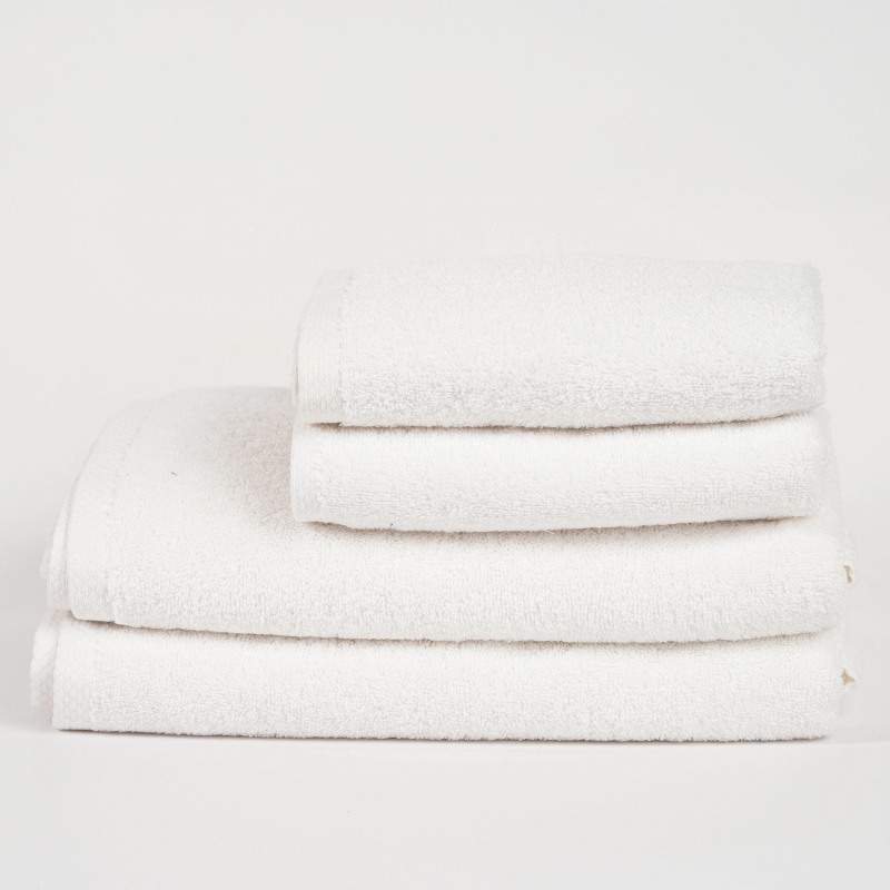 Main Bundle Image: “White bathroom essentials bundle with bamboo laundry basket, pure white towels, white bath mat, and transparent anti-slip mat.”