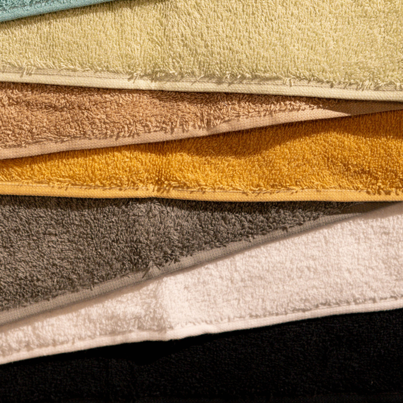 Absorbent soft white cotton towel folded neatly.