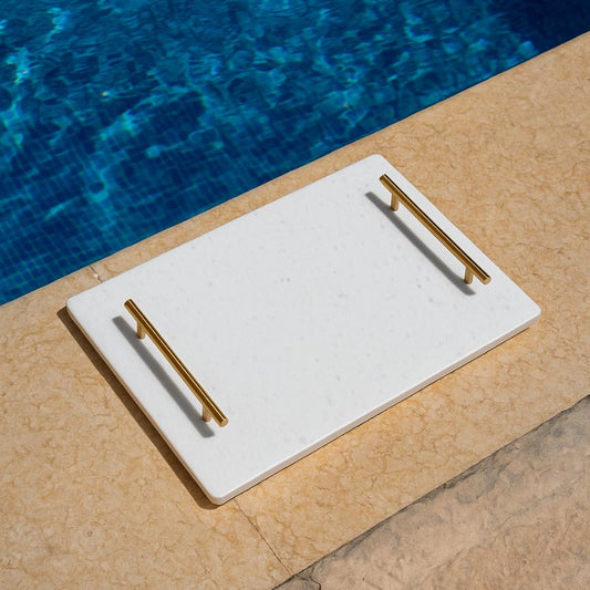  white marble tray with brass handles next to pool – luxury serving tray