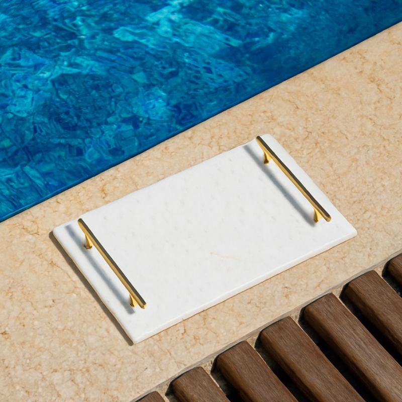  white marble tray with brass handles next to pool – luxury serving tray